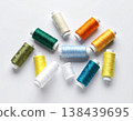 Multicolored threads. Colorful sewing thread spools on a white background. 138439695