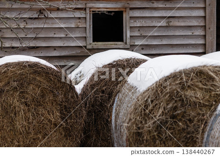 Snow Covered Hay Bales Beside Barn 138440267