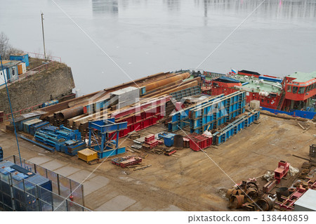 Industrial waterfront scene. Harbor with pipes and barges Industrial waterfront scene. Harbor with pipes and barges 138440859
