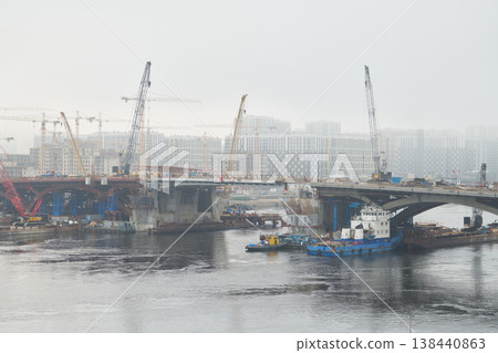 Building bridge spans with heavy lifting equipment present Building bridge spans with heavy lifting equipment present 138440863