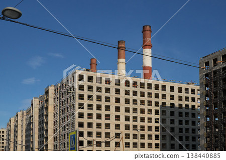 City Structures Under Bright Sky. Industrial Features Overshadow Residential Neighborhood Structures City Structures Under Bright Sky. Industrial Features Overshadow Residential Neighborhood Structures 138440885