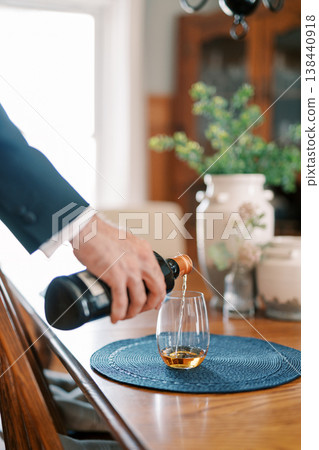 Executive Pouring Whiskey At Dining Table Executive Pouring Whiskey At Dining Table 138440918