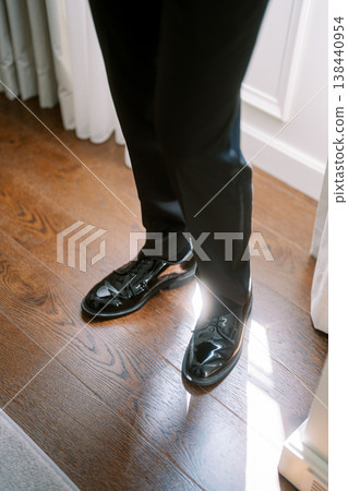 Caucasian Businessman Adjusting Polished Dress Shoes Caucasian Businessman Adjusting Polished Dress Shoes 138440954