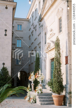 Quiet Orangehued Courtyard Lined With Cypress Plants Quiet Orangehued Courtyard Lined With Cypress Plants 138440955