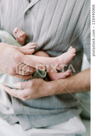 Baby Feet Embrace. Father Cradles Infant In Hands. Gentle Skin Contact Symbolizes Love And Family Intimacy Baby Feet Embrace. Father Cradles Infant In Hands. Gentle Skin Contact Symbolizes Love And Family Intimacy 138440966