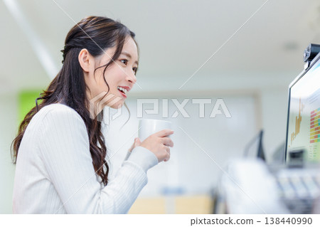 Female employees holding remote meetings in the office Female employees holding remote meetings in the office 138440990