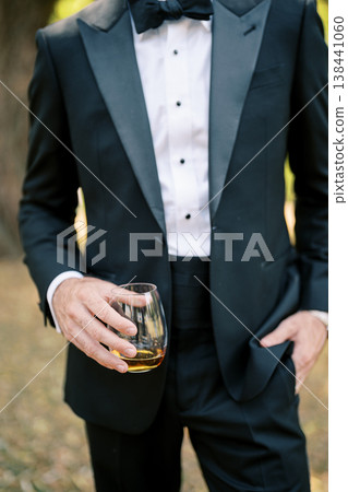 Tuxedo Groom Holding Whiskey Glass Tuxedo Groom Holding Whiskey Glass 138441060