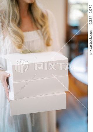 Bakery Owner Delivering Stacked Boxes Bakery Owner Delivering Stacked Boxes 138441072