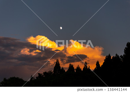 Evening scenery of clouds and moon illuminated by the setting sun Evening scenery of clouds and moon illuminated by the setting sun 138441144