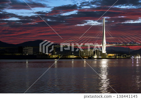 A sunset over Kesennuma Bay and a waterside landscape with a crescent moon. A sunset over Kesennuma Bay and a waterside landscape with a crescent moon. 138441145