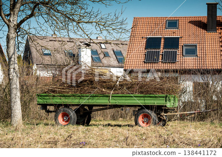 Old Farm Trailer In Meadow Near Village Houses: Rural Agricultural Scene In Bavarian Countryside Old Farm Trailer In Meadow Near Village Houses: Rural Agricultural Scene In Bavarian Countryside 138441172
