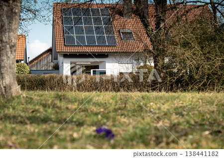 House With Solar Panels Behind Spring Meadow: Residential Scene With Blooming Grass In Bavarian Countryside 138441182