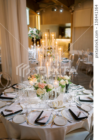 Glamorous Banquet Table With Tall Candles And Gold Accents Glamorous Banquet Table With Tall Candles And Gold Accents 138441364