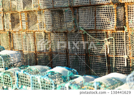 Crab Trap Stacked Against the Harbor Wall During Crab Trap Stacked Against the Harbor Wall During 138441629