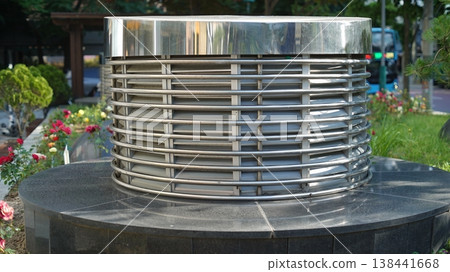 Cylinder-shaped metal ventilation facility in front of a shopping center in Seoul, Korea Cylinder-shaped metal ventilation facility in front of a shopping center in Seoul, Korea 138441668