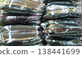 Eggplants wrapped in plastic wrap in a vegetable store 138441699