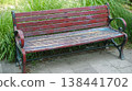 Old wooden bench with peeling red paint outdoors 138441702