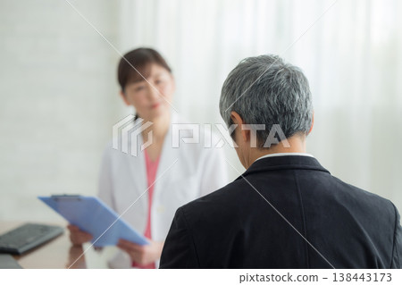 Doctor examining a senior man Doctor examining a senior man 138443173