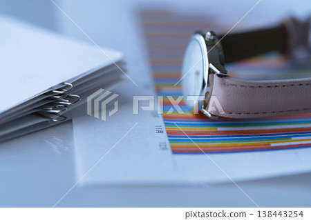 Graphs, documents, and a wristwatch on the table Graphs, documents, and a wristwatch on the table 138443254