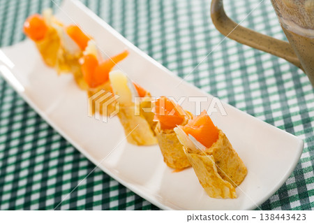 Pancakes rolls with salted salmon on a plate Pancakes rolls with salted salmon on a plate 138443423