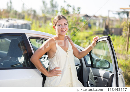 European girl has arrived in village, comes out of car 138443557