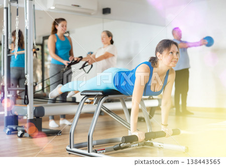Woman doing exercises on wunda chair in pilates studio 138443565