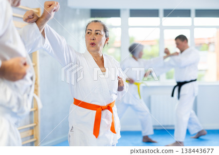 Senior karate practitioner engage in fierce fight oriental single combat Senior karate practitioner engage in fierce fight oriental single combat 138443677