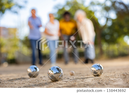 View of patanque shiny metal balls laying on the ground outdoors in the sun View of patanque shiny metal balls laying on the ground outdoors in the sun 138443692
