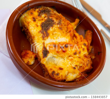 Top view of traditional italian meat lasagna with grated cheese served in clay plate Top view of traditional italian meat lasagna with grated cheese served in clay plate 138443857