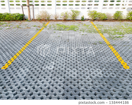 Eco Friendly Permeable Paver Parking Lot with Yellow Lines Eco Friendly Permeable Paver Parking Lot with Yellow Lines 138444186