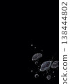 A pointillist illustration of round jellyfish and bubbles floating in the deep sea (on a jet-black background). 138444802