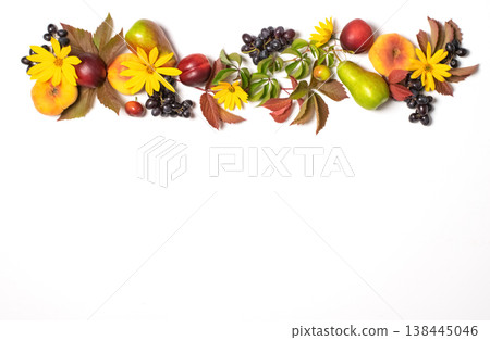 Autumn fruits apples pears grapes fallen leaves lined with frame white background. Thanksgiving harvest concept Autumn fruits apples pears grapes fallen leaves lined with frame white background. Thanksgiving harvest concept 138445046