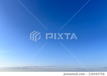 A clear blue sky with white clouds that still bear the glow of the morning sun. A clear blue sky with white clouds that still bear the glow of the morning sun. 138445749