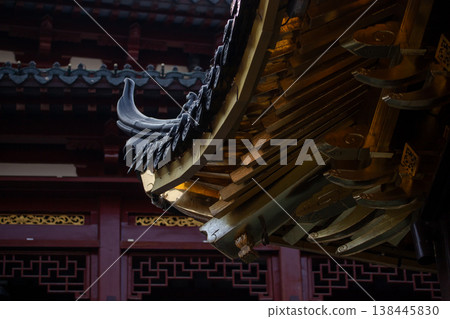 Detail of traditional Asian temple architecture, specifically highlighting the intricate curved roof structure and ornate eaves Detail of traditional Asian temple architecture, specifically highlighting the intricate curved roof structure and ornate eaves 138445830