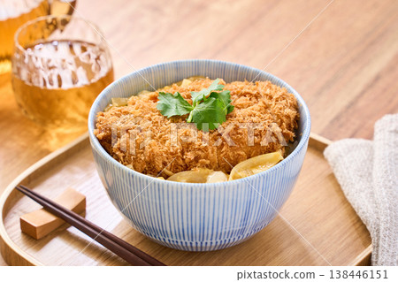 Katsudon: Pork cutlet served over egg, garnished with mitsuba (Japanese parsley). Katsudon: Pork cutlet served over egg, garnished with mitsuba (Japanese parsley). 138446151