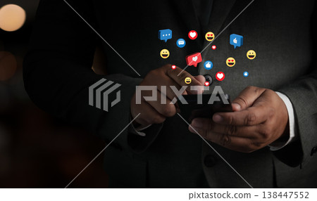 Man holding smartphone with social media reactions and notifications, representing mobile communication, user engagement, digital interaction, and online marketing concept playing social media online Man holding smartphone with social media reactions and notifications, representing mobile communication, user engagement, digital interaction, and online marketing concept playing social media online 138447552