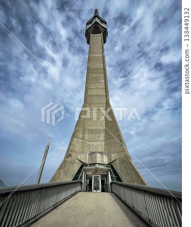 Entrance to the Avala TV tower with a spectacular view of the sky and the concrete structure. 138449132