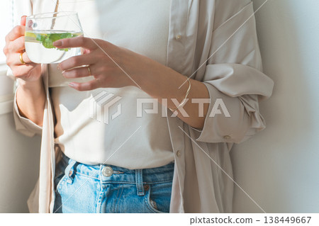 Women who drink detox water, lemon water, and mint water. Women who drink detox water, lemon water, and mint water. 138449667