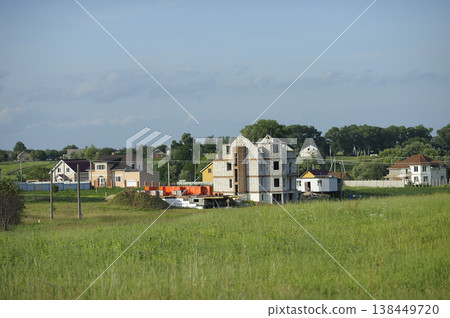 Construction of a new houses in the Ukrainian countryside on a sunny summer day Construction of a new houses in the Ukrainian countryside on a sunny summer day 138449720