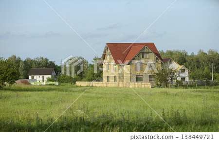 Construction of a new houses in the Ukrainian countryside on a sunny summer day Construction of a new houses in the Ukrainian countryside on a sunny summer day 138449721