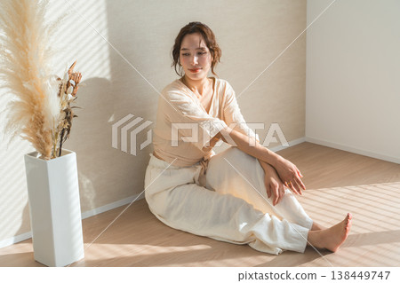 A woman by the window in the setting sun (model, fashion, light, shadow) 138449747