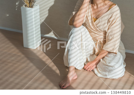 A woman by the window in the setting sun (model, fashion, light, shadow) 138449810