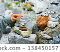 Relaxed spiritually child's hand arrangement pebble tower. Yoga relax meditation 138450157