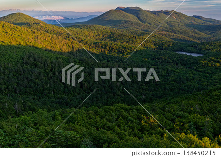 Morning view of Shirakoma Pond and the mountain range of the Northern Yatsugatake Mountains and Northern Alps from Nyū in the Northern Yatsugatake Mountains. Morning view of Shirakoma Pond and the mountain range of the Northern Yatsugatake Mountains and Northern Alps from Nyū in the Northern Yatsugatake Mountains. 138450215