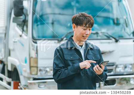 Truck driver operating smartphone 138450289