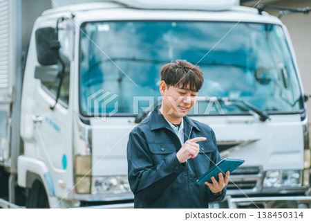 Truck drivers and tablet devices 138450314