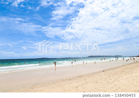 A beach under a clear blue sky 138450455