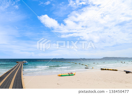 A beach and floating pier under a clear blue sky A beach and floating pier under a clear blue sky 138450477