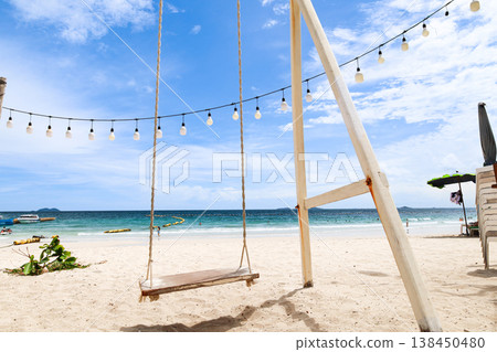 A beach with a blue sky and a swing 138450480