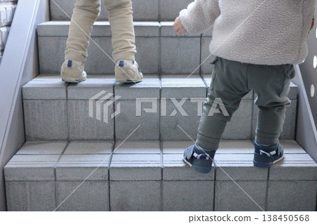 At the feet of two children struggling to climb the stone steps At the feet of two children struggling to climb the stone steps 138450568